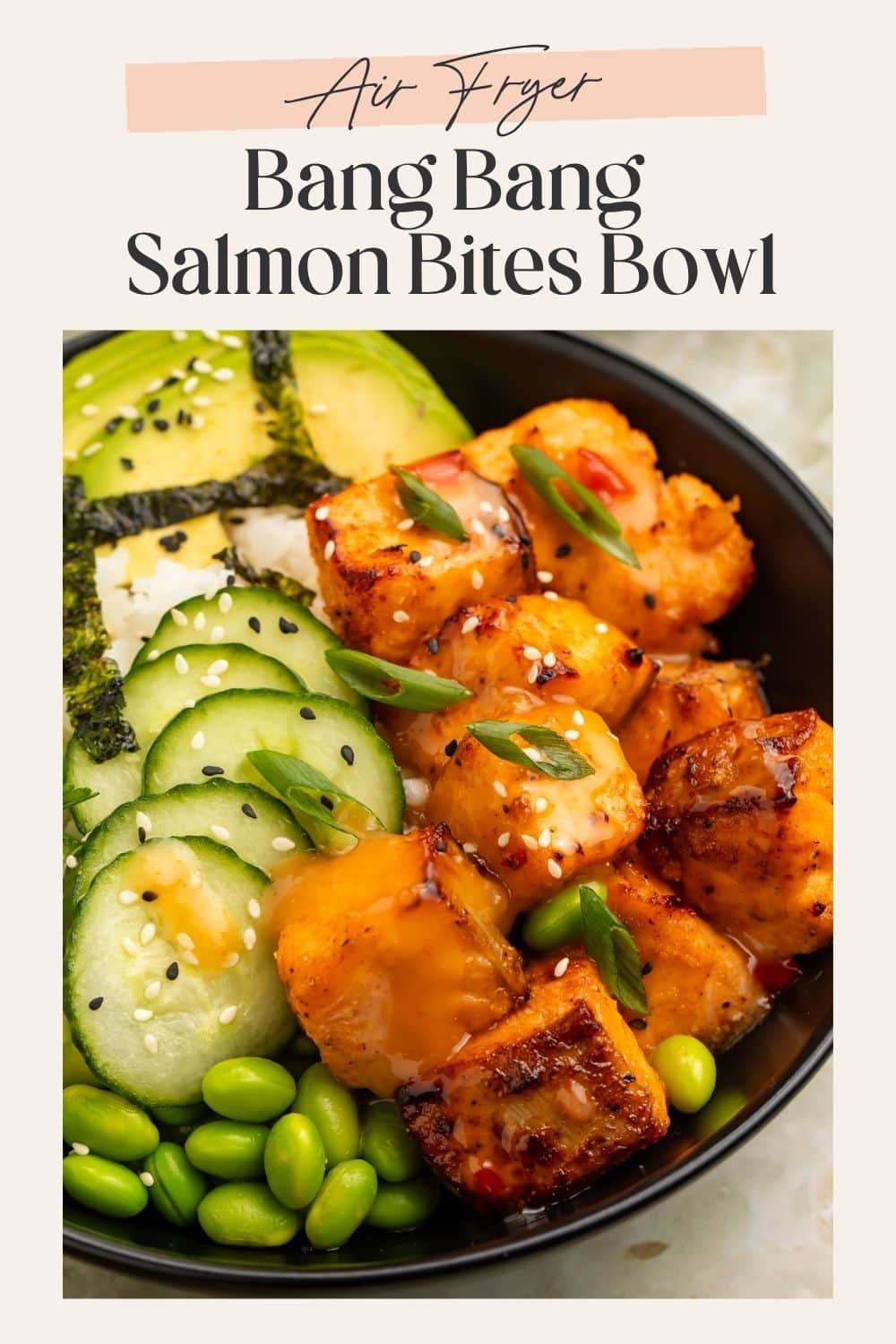 Air fryer bang bang salmon bites bowl with crispy salmon, avocado, cucumber, edamame, and sesame seeds