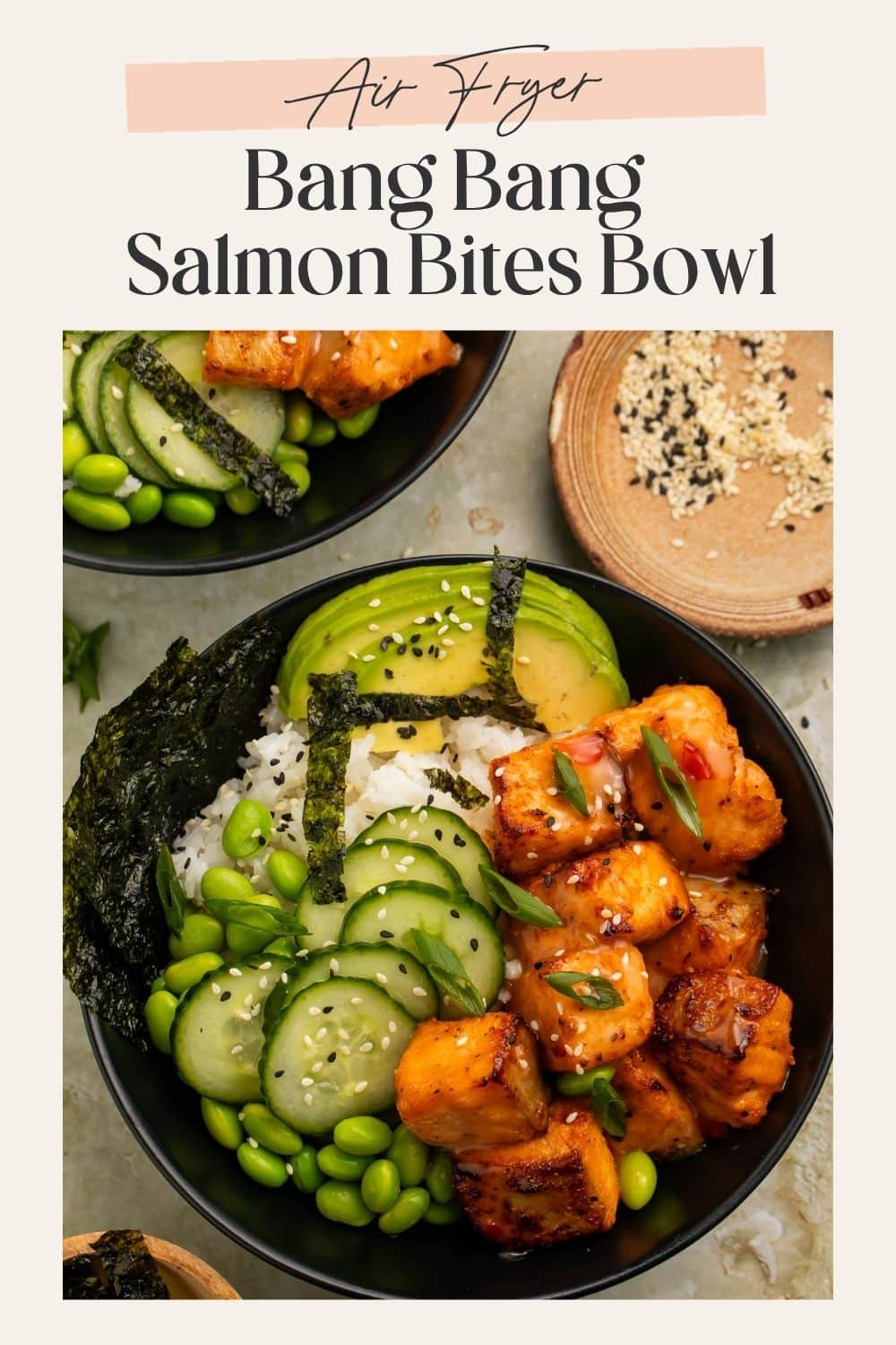 Pinterest graphic featuring bang bang salmon bites bowls with rice, avocado, cucumber, edamame, and seaweed