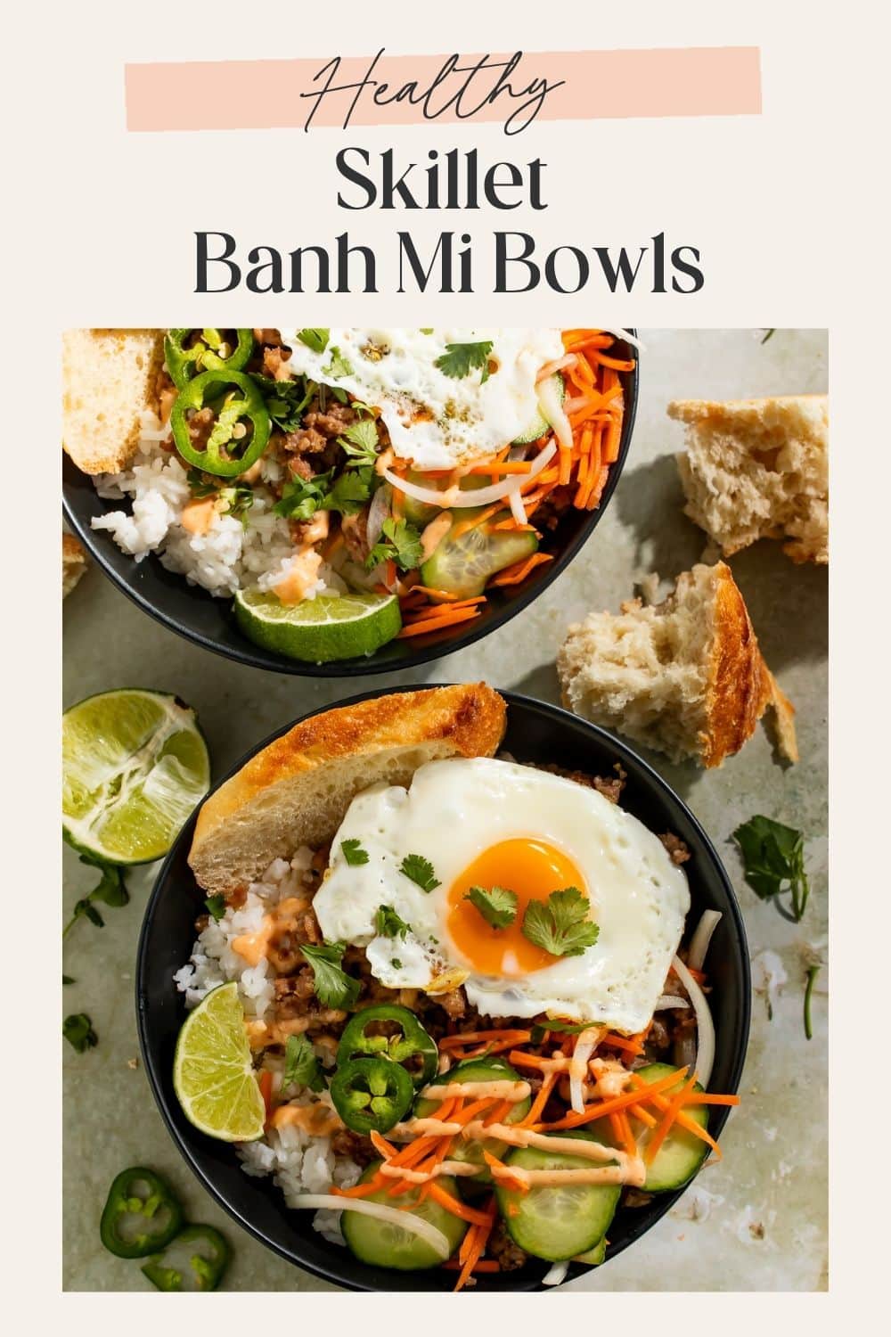 Close-up Pinterest pin for skillet banh mi bowls with fried egg, rice, cucumber, pickled carrots, jalapeños, and spicy sauce
