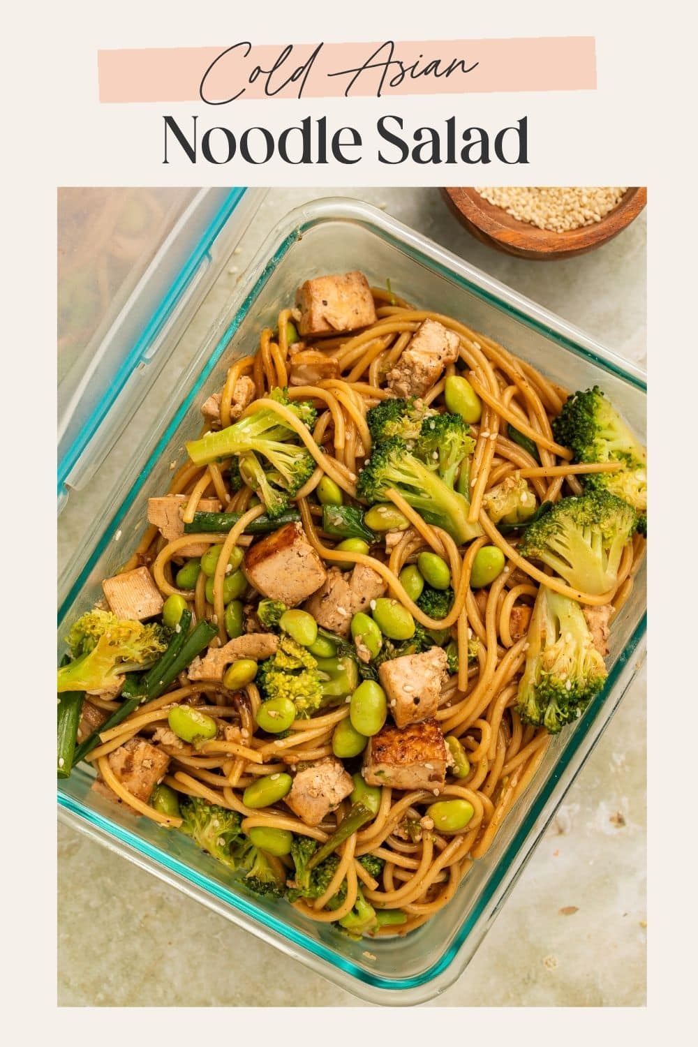 Overhead image of a glass meal prep container with a noodle, tofu and broccoli salad. There is a frame on the image with Pinterest-optimised text.