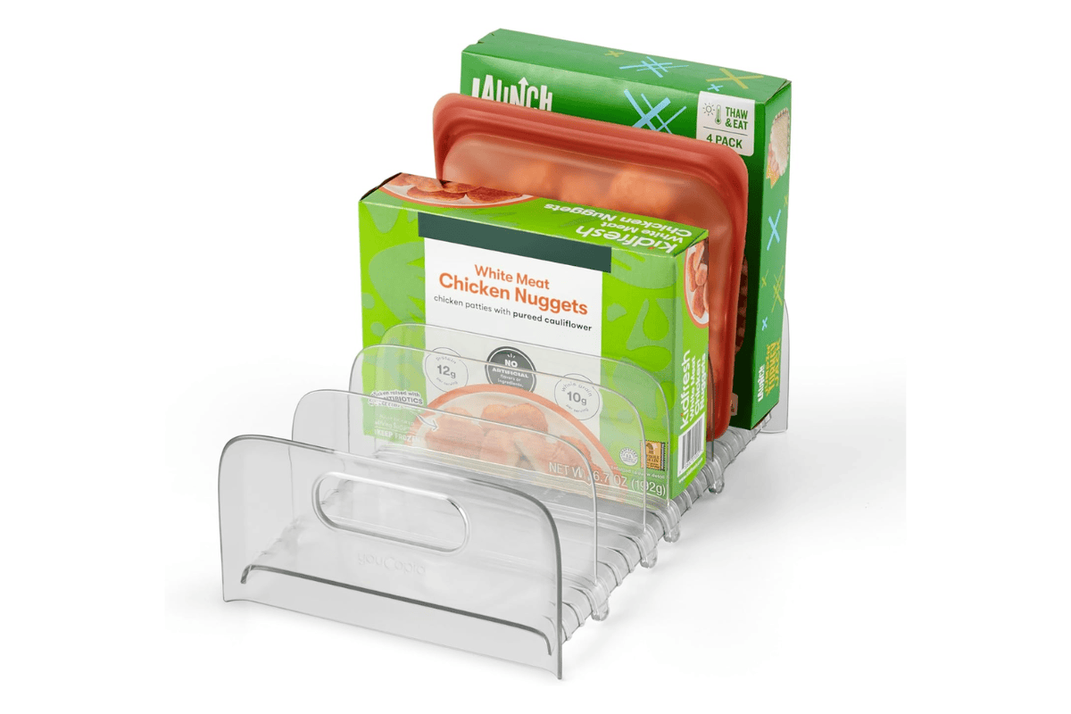 Clear freezer organizer bin holding frozen boxed foods and silicone storage containers