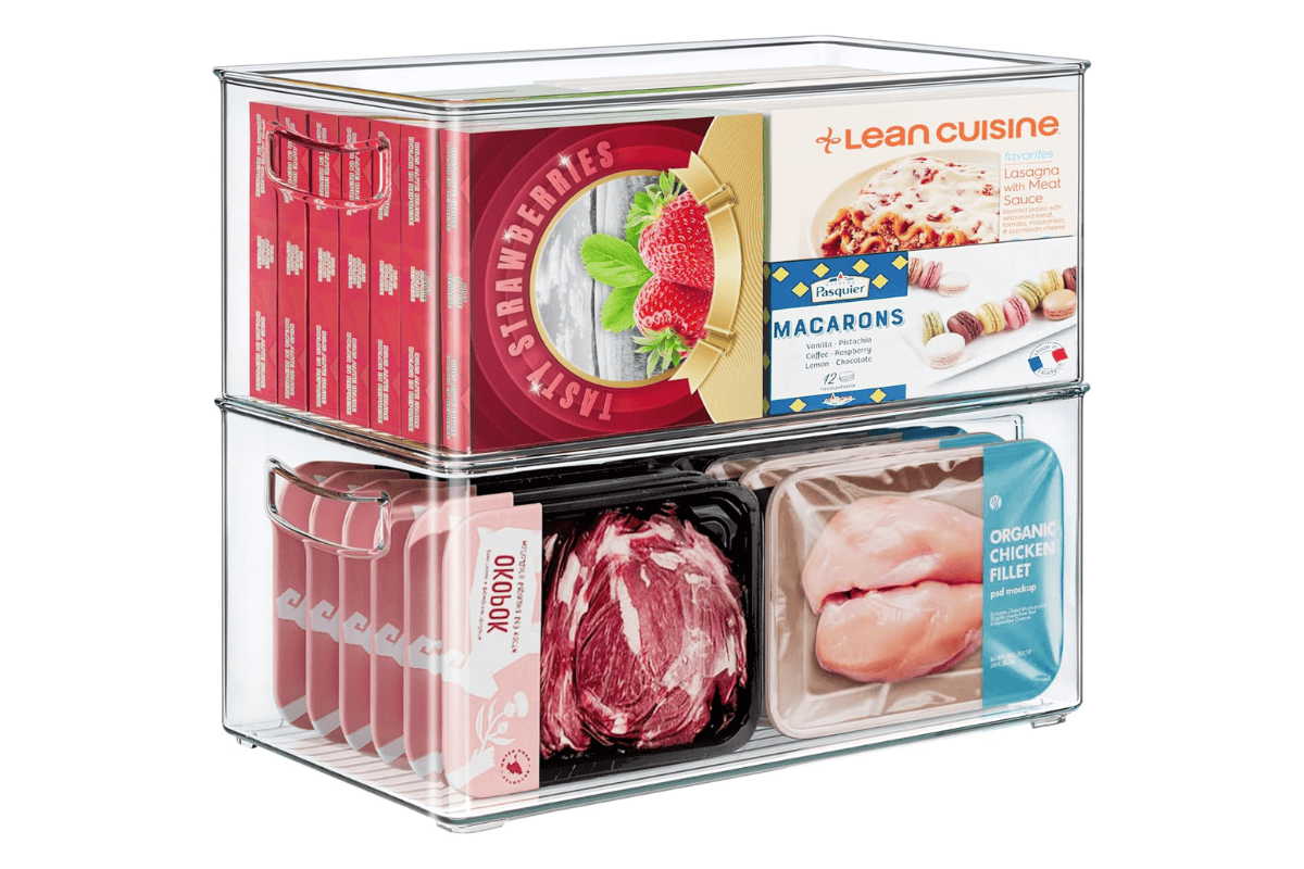 Stackable clear freezer bins organized with frozen meals, packaged meats, and boxed foods