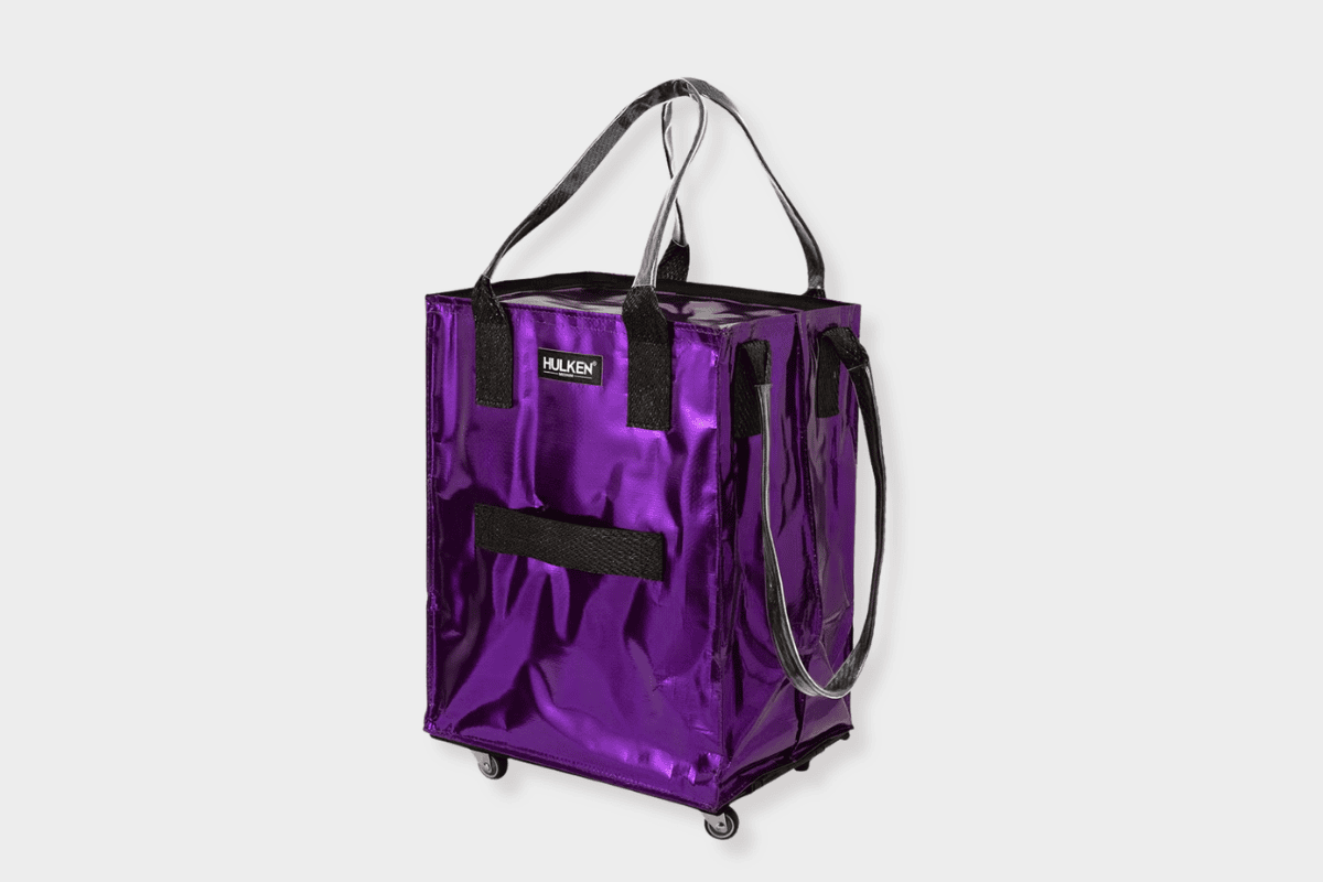 Metallic purple Hulken rolling tote bag with black handles and four swivel wheels