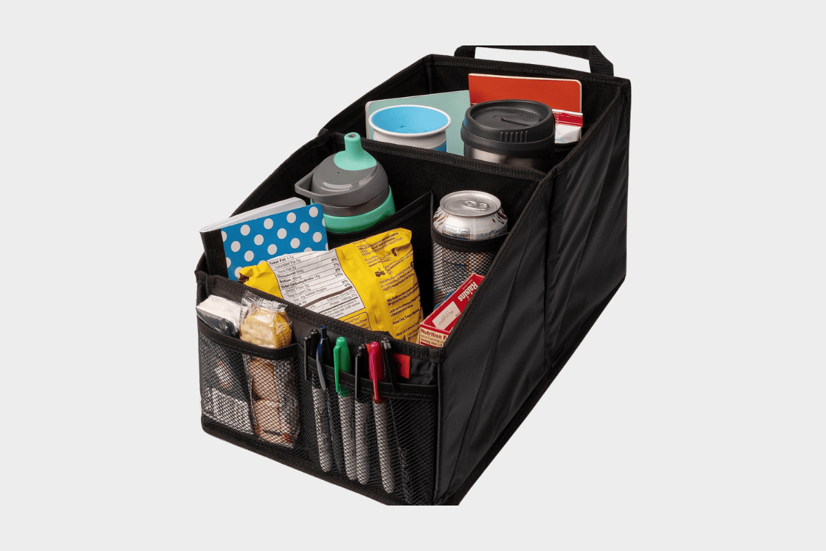 Black collapsible car trunk organizer filled with snacks, drinks, cups, and markers
