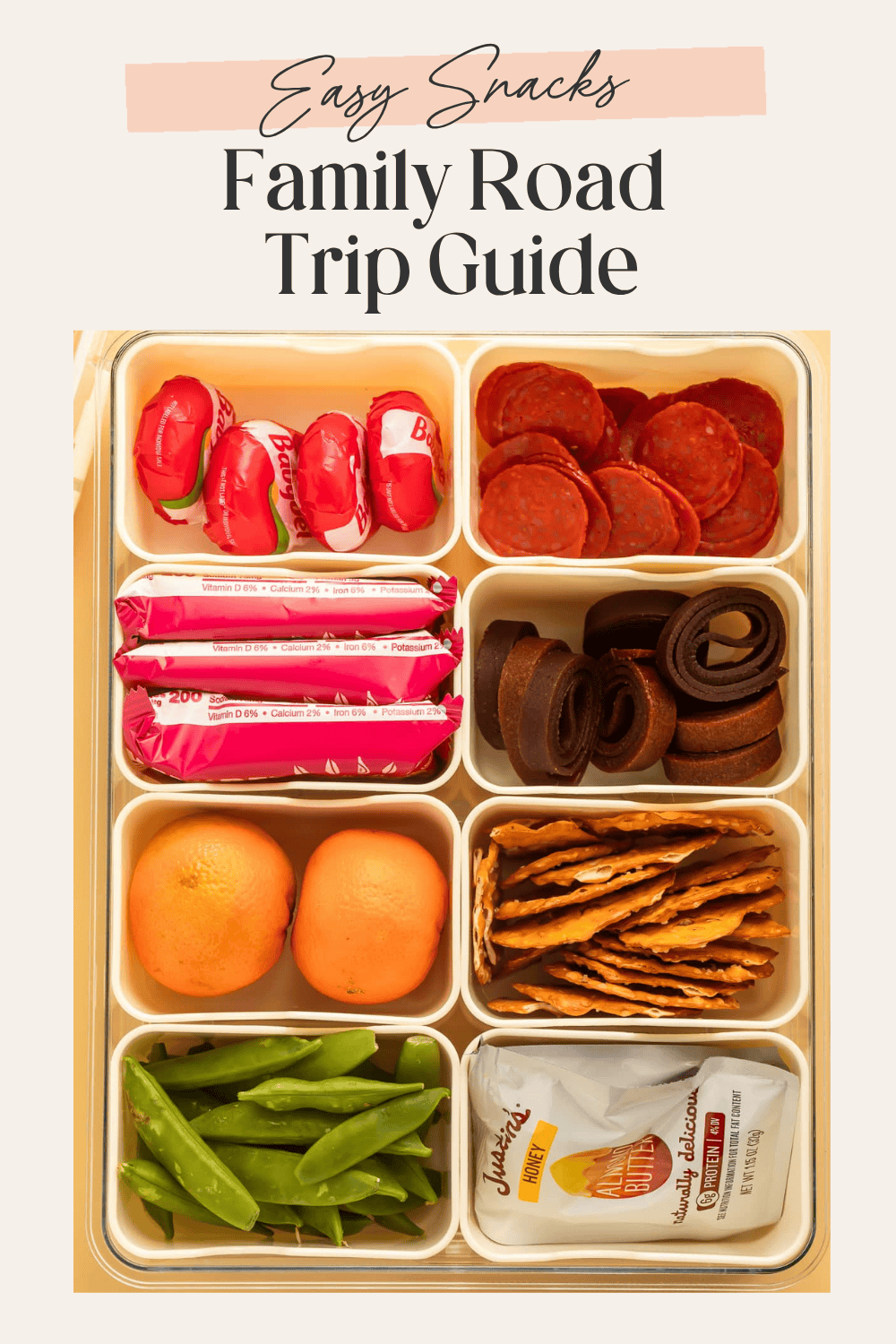 Bento box snack tray filled with pepperoni, cheese, fruit, snap peas, and crackers for road trip