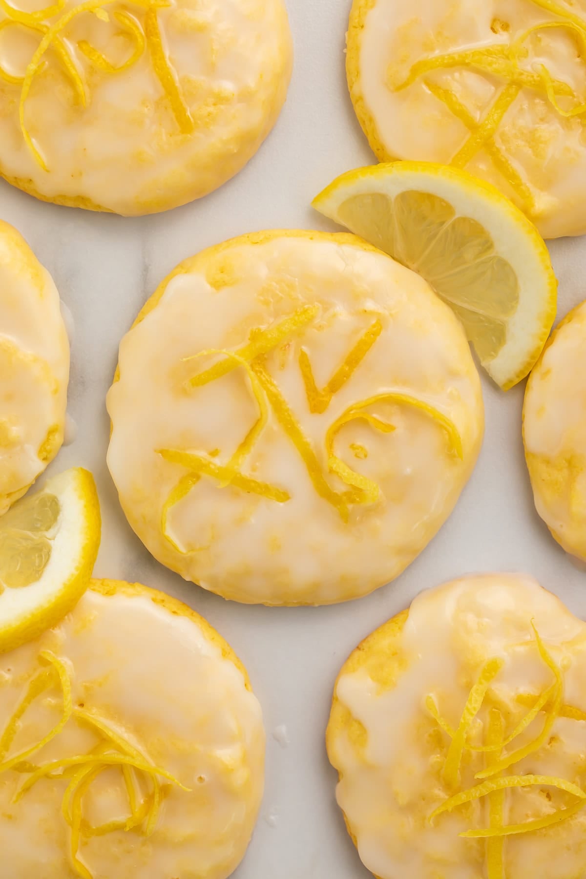 Close up of lemon cookies with lemon zest in the glaze.