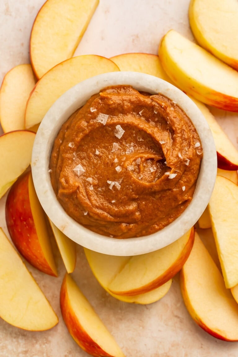 Raw salted caramel dip served with sliced apples for dipping