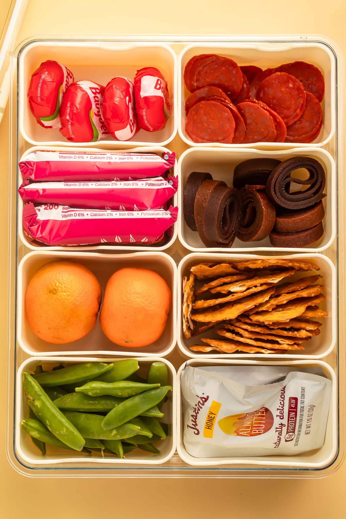 An eight section snackle box pictured overhead filled with treats.