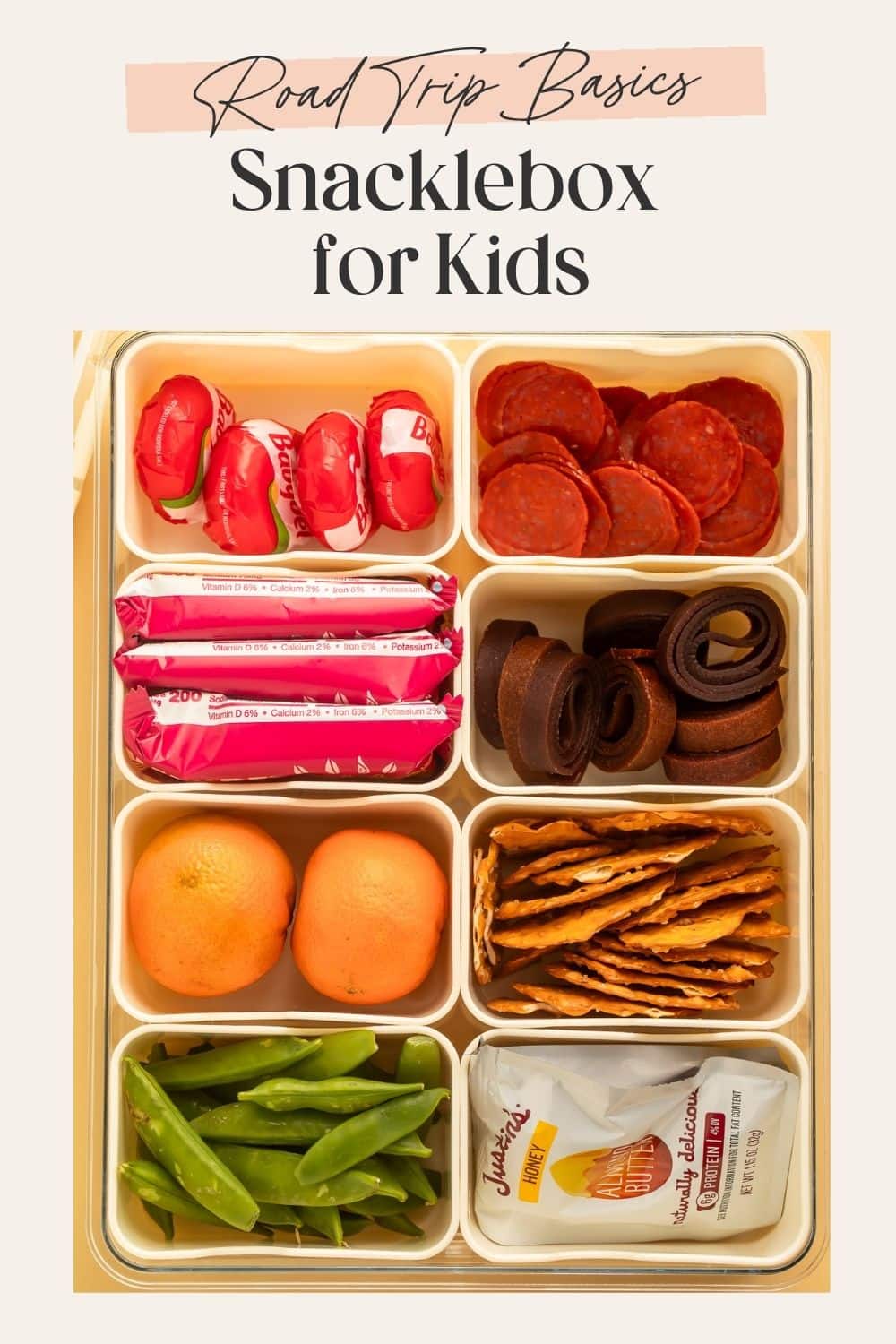 Eight-compartment snackle box with fresh fruit, crackers, salami and vegetables. There is a frame on the image with Pinterest-optimised text.