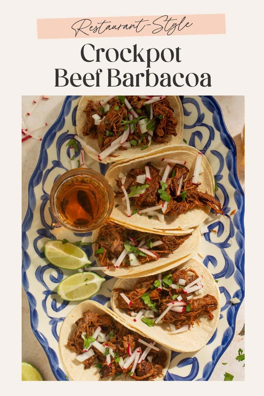 Blue and white platter of shredded beef tacos, pictured overhead. There is a frame on the image with Pinterest-optimised text.