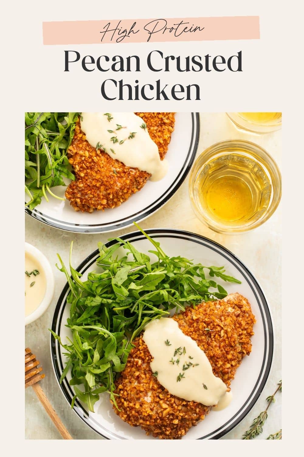 Two plates of pecan crusted chicken with rocket and a creamy honey mustard sauce. There is a frame on the image with Pinterest-optimized text.