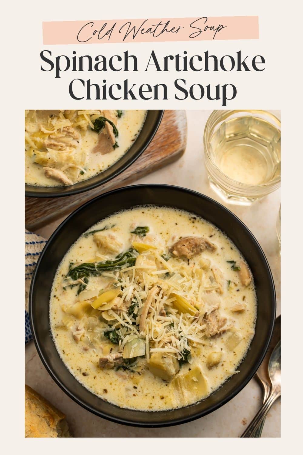 Overhead image of a creamy chicken, spinach and artichoke soup topped with shredded cheese. There is a frame on the image with Pinterest-friendly text.