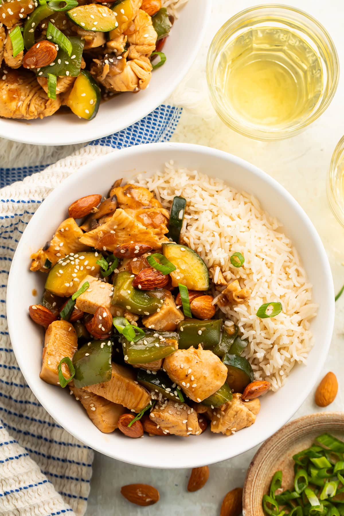 Bowl of almond chicken and vegetable stir fry and rice.