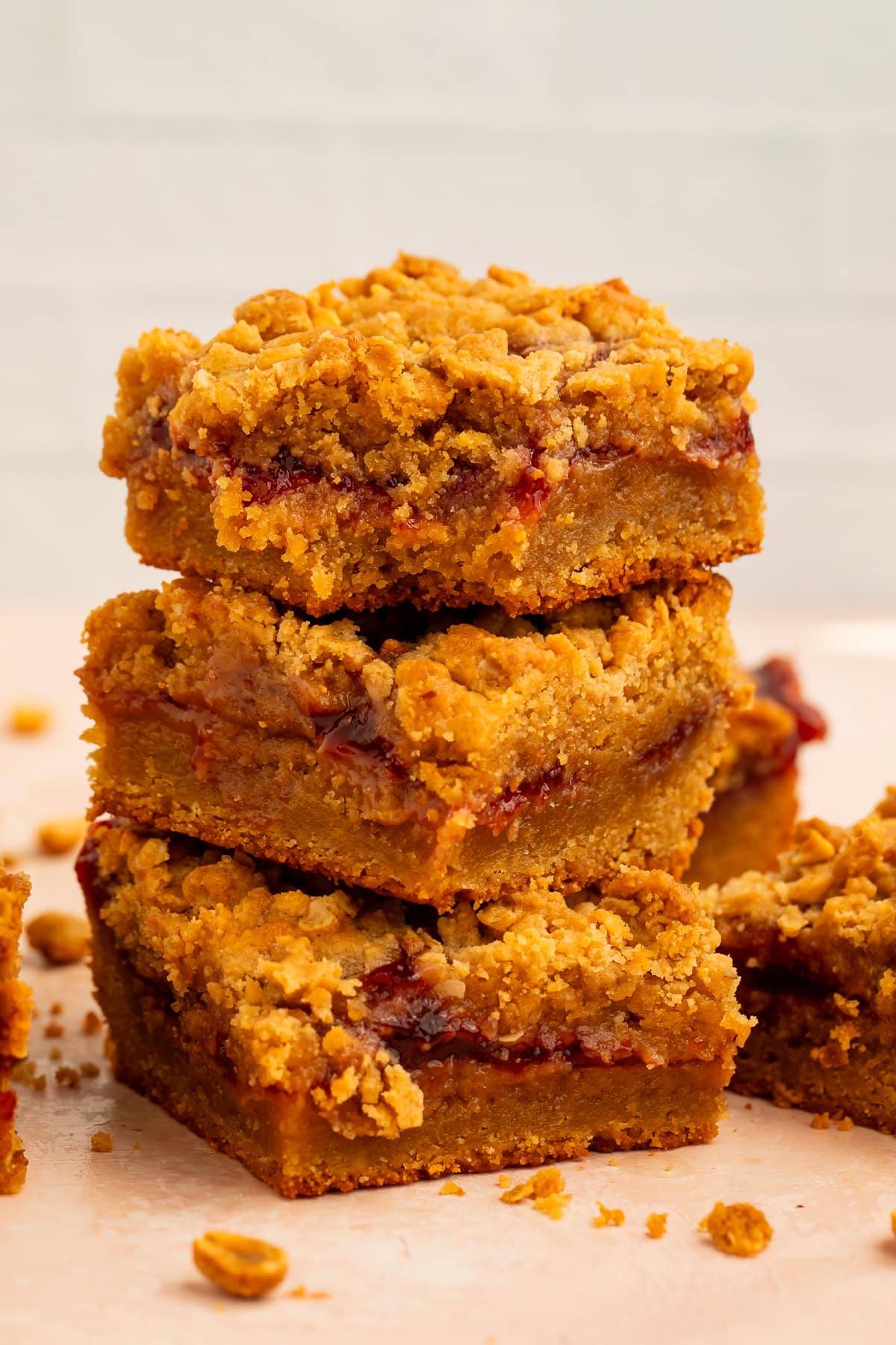 Three peanut butter and jelly bars stacked on top of each other.