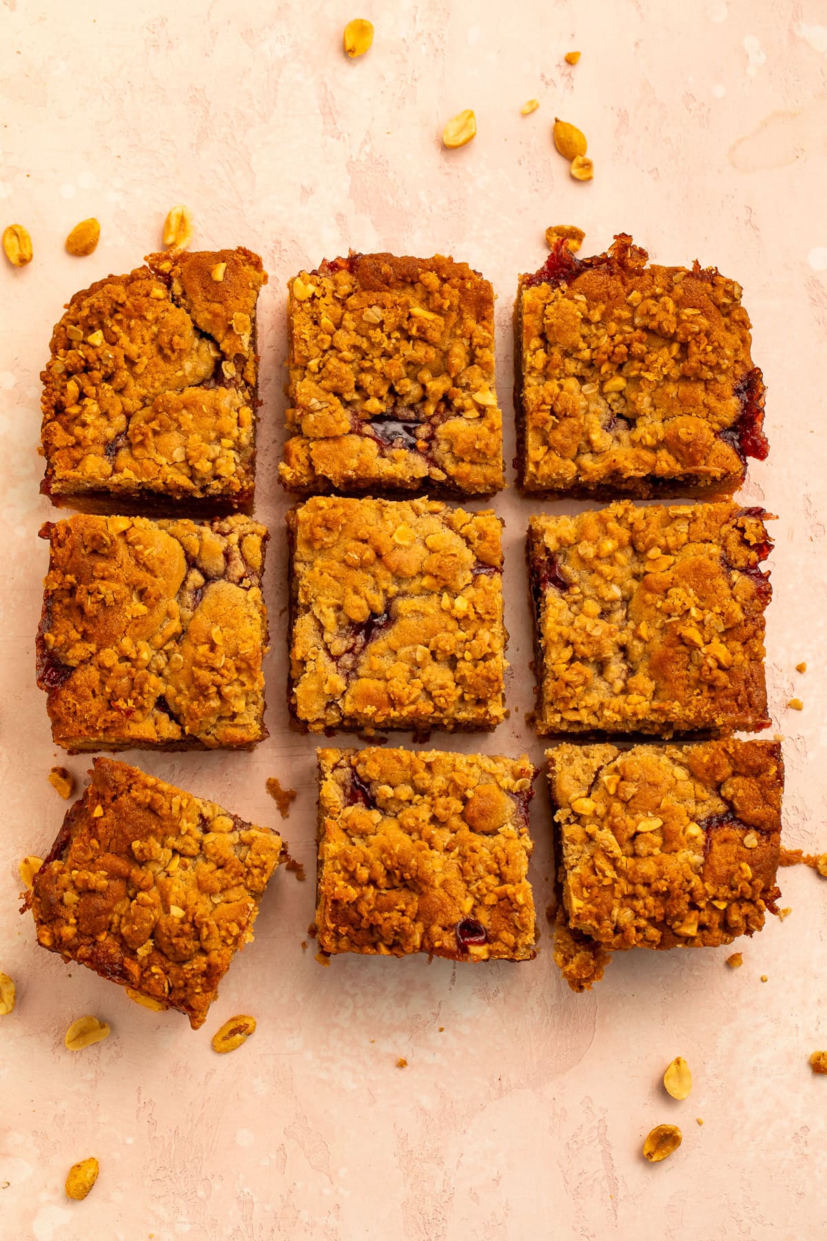 Overhead image of a slab of peanut butter and jelly bars that have been cut into nine.