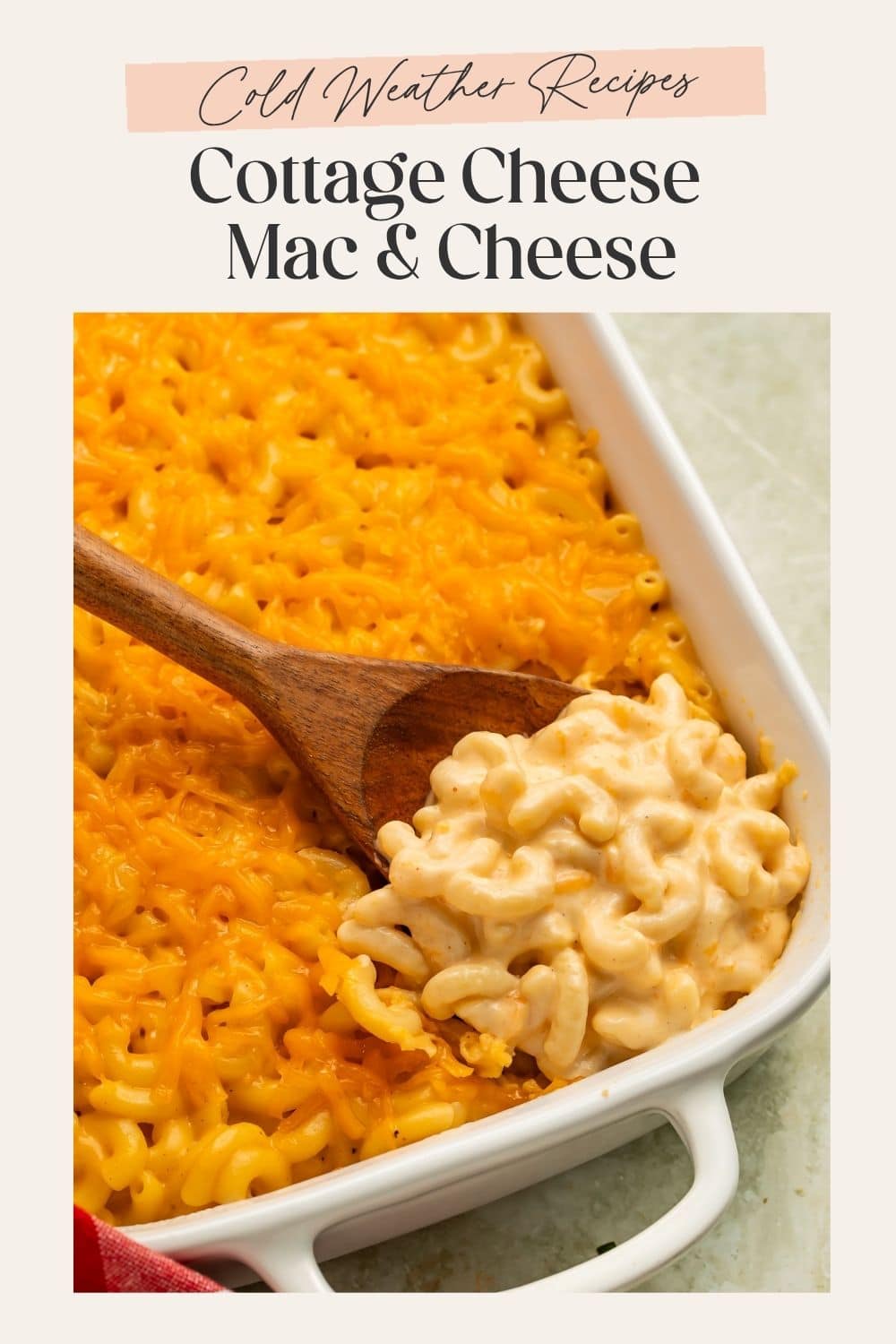 Close up of mac and cheese being scooped out of a baking dish, There is a frame on the picture with Pinterest-friendly text.