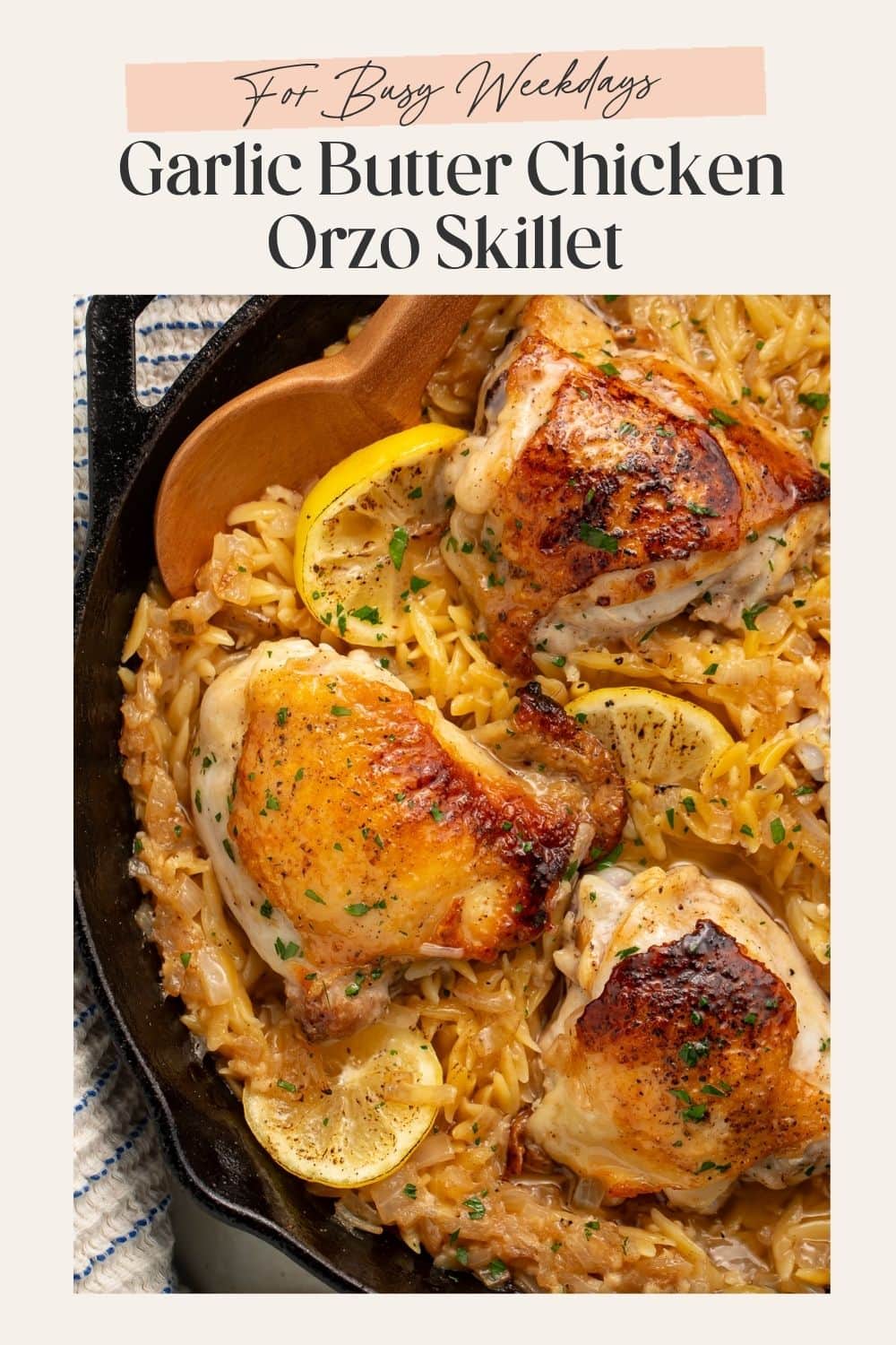 Close up of a chicken and orzo skillet ith lemon slices. There is a frame on the image with Pinterest friendly text.