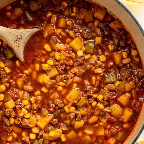 Wooden spoon in a pot of Cowboy soup.
