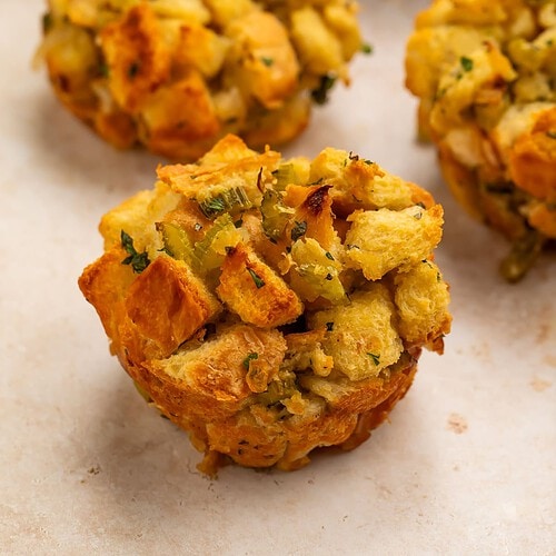 Close up of three stuffing muffins removed from the muffin pan.